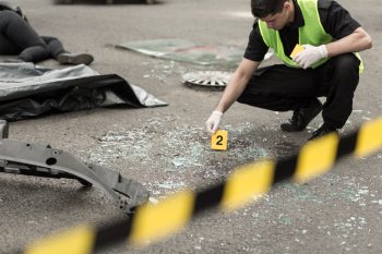 Policeman marking evidence at crime scene