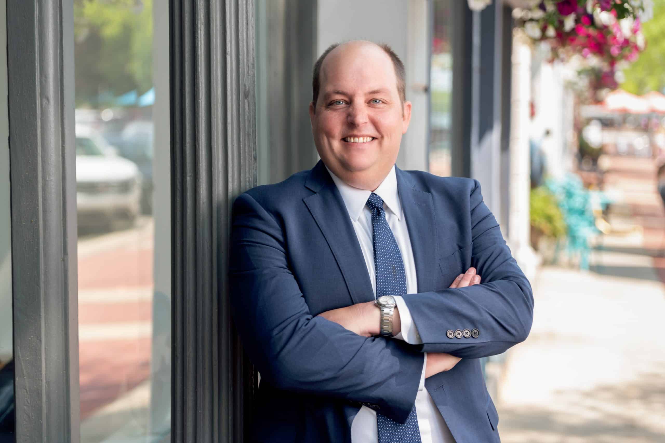 personal injury attorney kyle melling standing in front of lowe scott fisher's office in chardon, oh