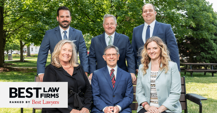 Attorneys at lowe scott fisher in group shot with a best lawyers in america badge for 2024 best law firms rankings in lower left corner