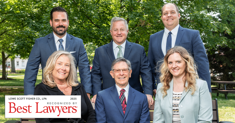 group shot of lowe scott fisher attorneys sitting on a bench in park with the "Best Lawyers 2025" badge overlaid on the picture